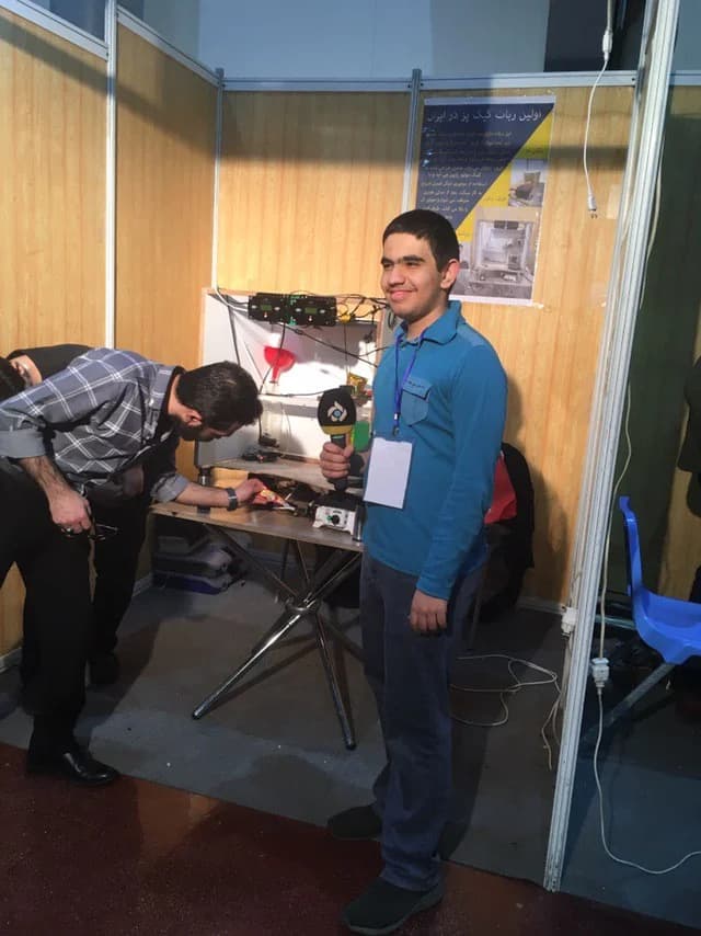 Ali with a robot at a competition