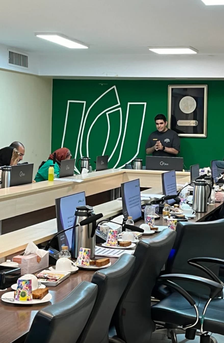 A group meeting with a speaker standing at the front